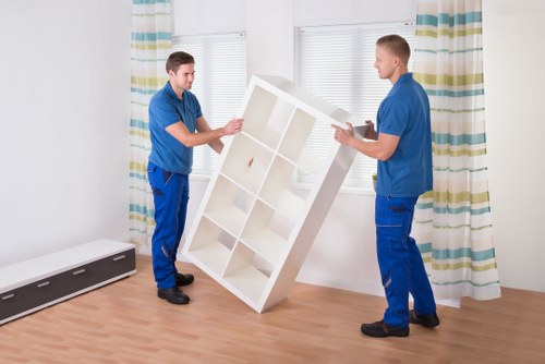 Professional movers loading furniture for a Childshill relocation